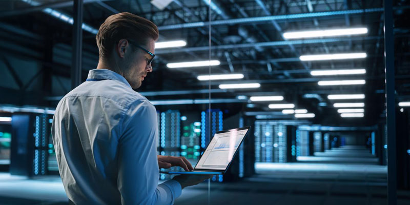 Man with laptop in data center